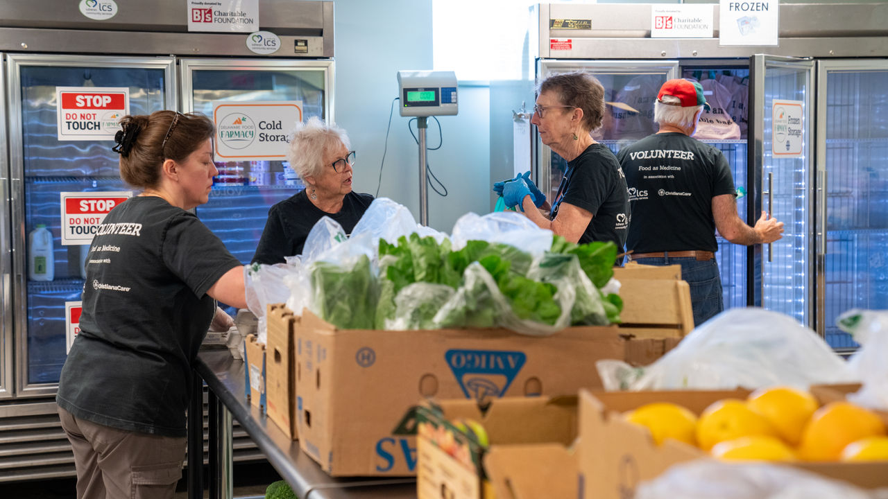 Volunteers organizing fresh produce in pantry Volunteers organizing fresh produce in pantry