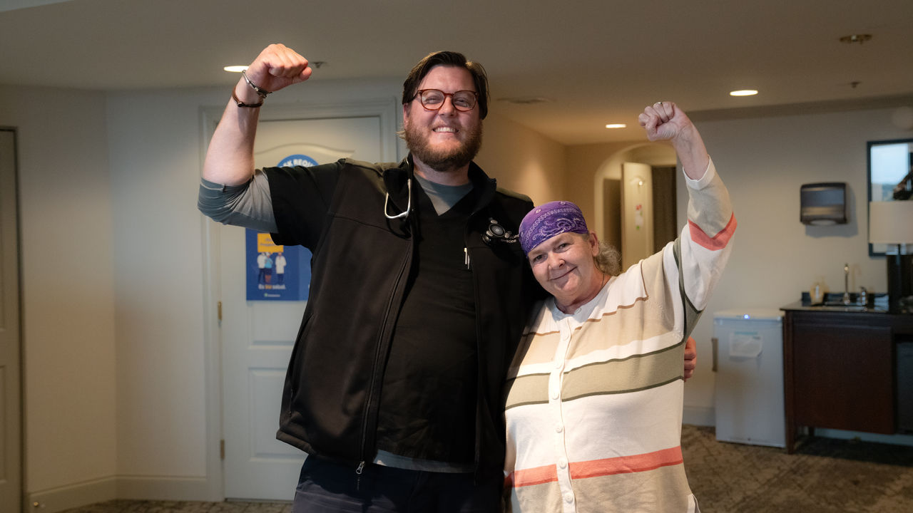 Community health doctor and patient cheering together Community health doctor and patient cheering together